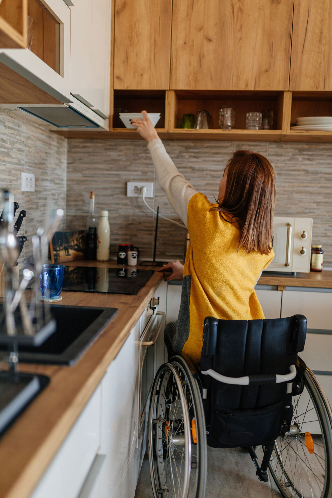 Female in wheelchair preparing breakfast at home